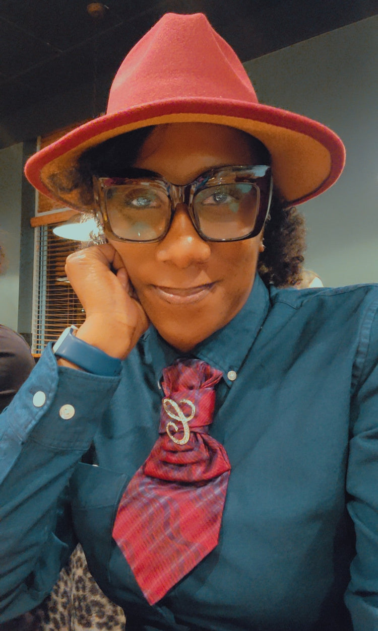 Model wearing a burgundy Diva Drape Tie styled as a fashion statement accessory from Tall Diva Boutique.